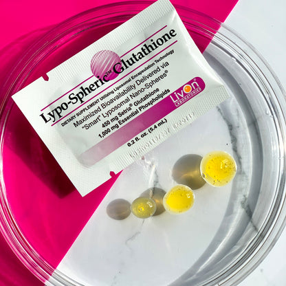 Lypo-Spheric Glutathione packets with capsules on a pink and white background