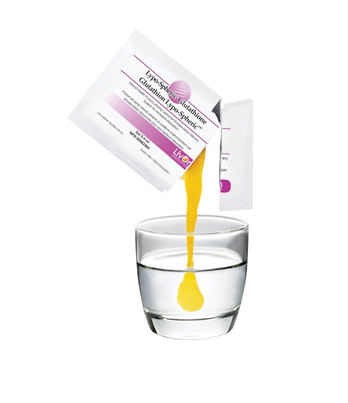 Yellow liquid being poured from a package into a glass of water on a white background
