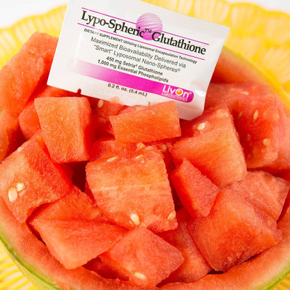 Lypo-Spheric Glutathione supplement packet on a bed of watermelon cubes.